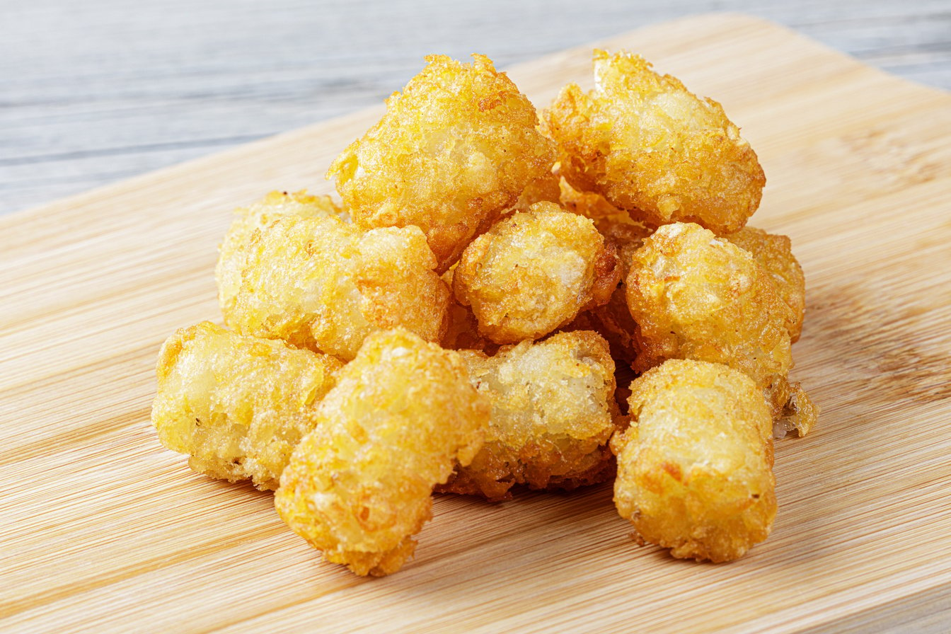 Close up of delicious Tater Tots on a wooden background